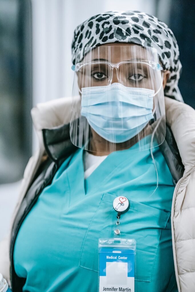 Healthcare worker wearing protective face shield and mask.