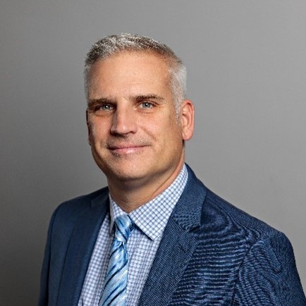 Professional man in a blue suit with a confident smile.